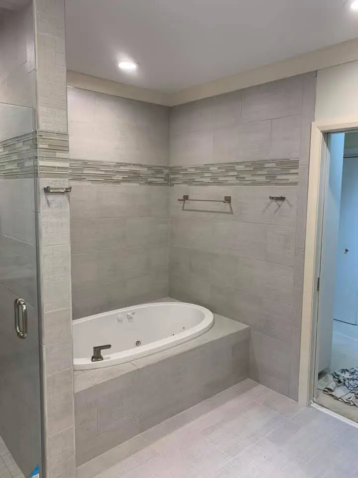 Completed bathroom with a glass shower and soaking tub